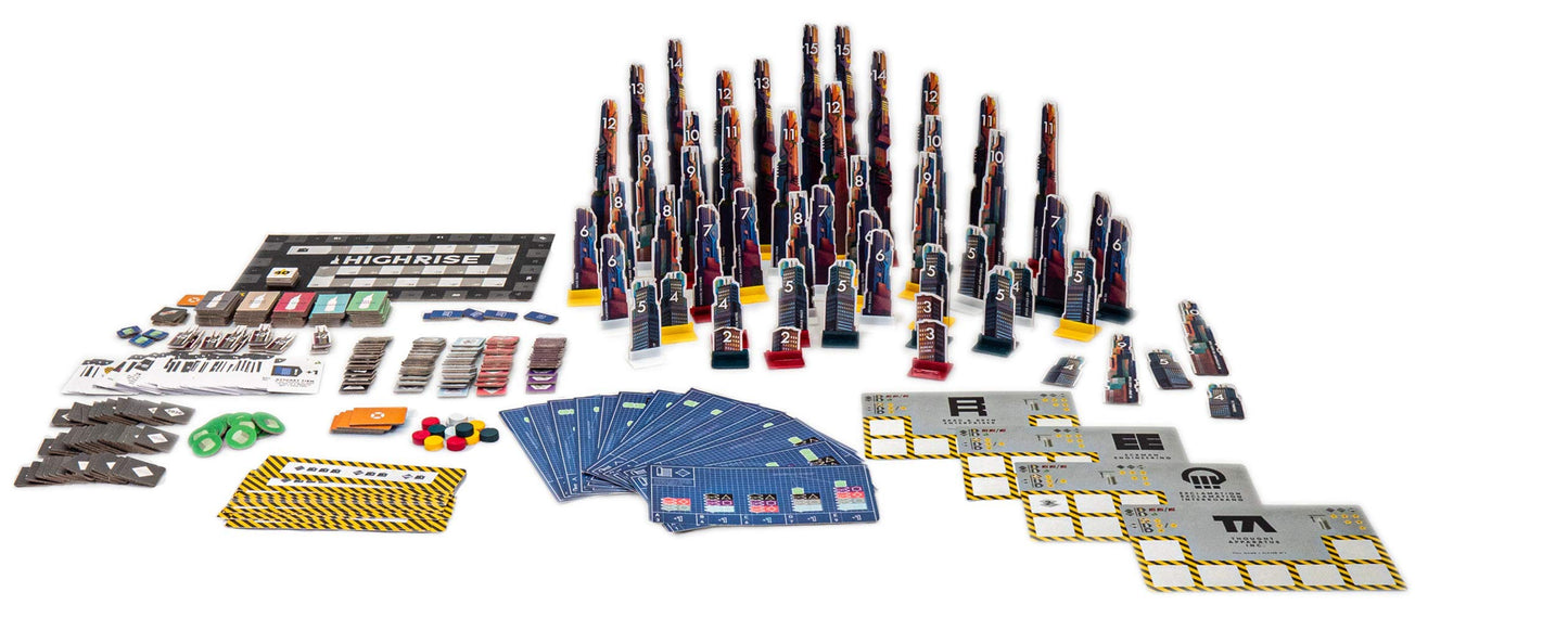 The High Rise board game components are spread out on a white surface, featuring a game board, numerous skyscraper standees, stacks of cards, and player mats