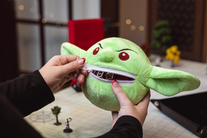 Pathfinder Goblin Plush Dice Bag held in a hand for scale