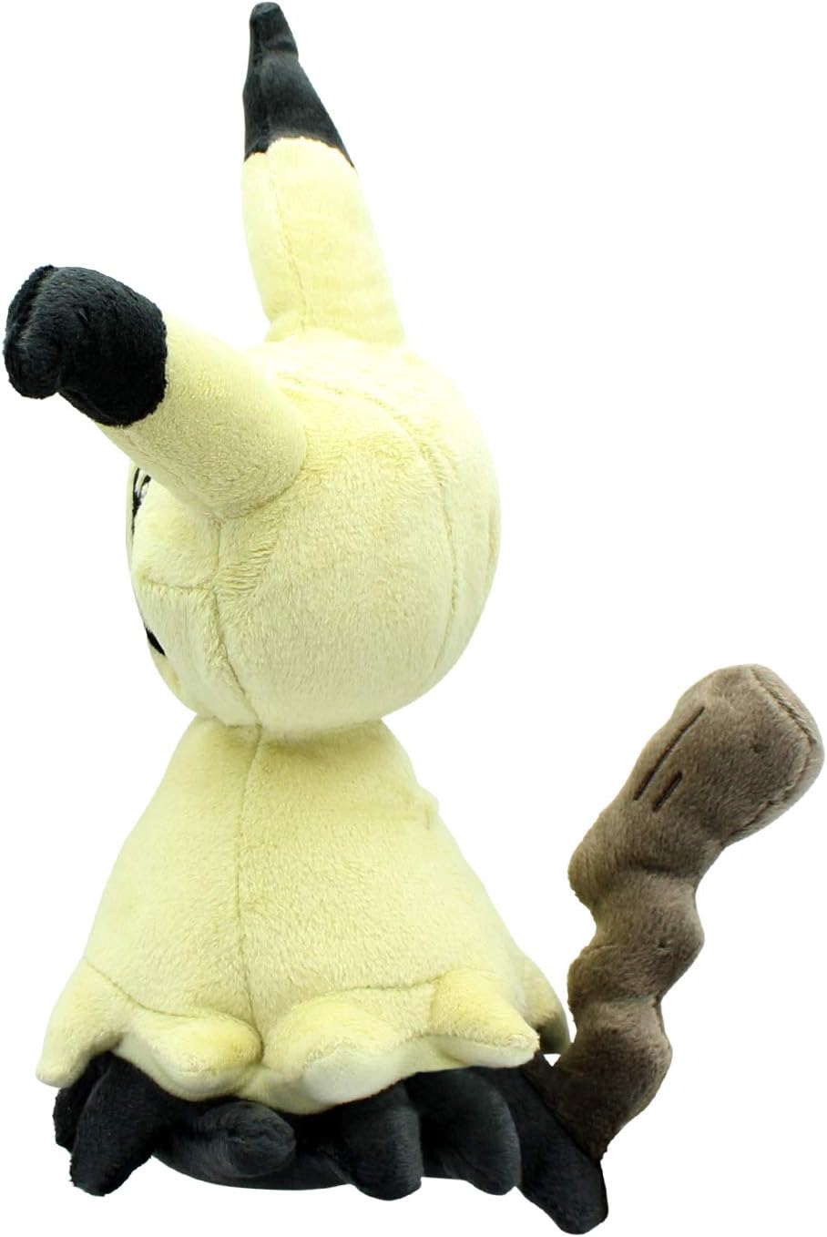 Pokémon Mimikyu plush toy, showing its pale yellow disguise, black ears, and wavy brown stick tail from the side