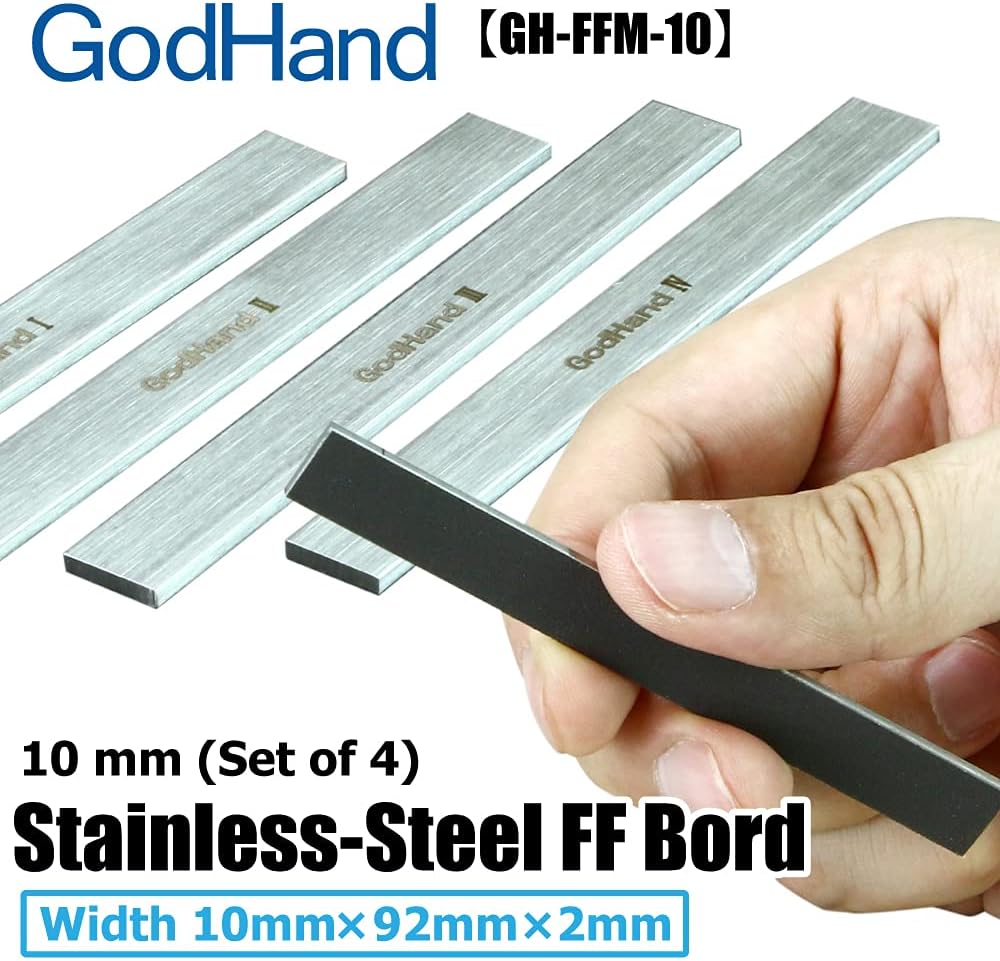 A hand holds a thin, black-sided stainless steel board. Three identical boards are visible behind it