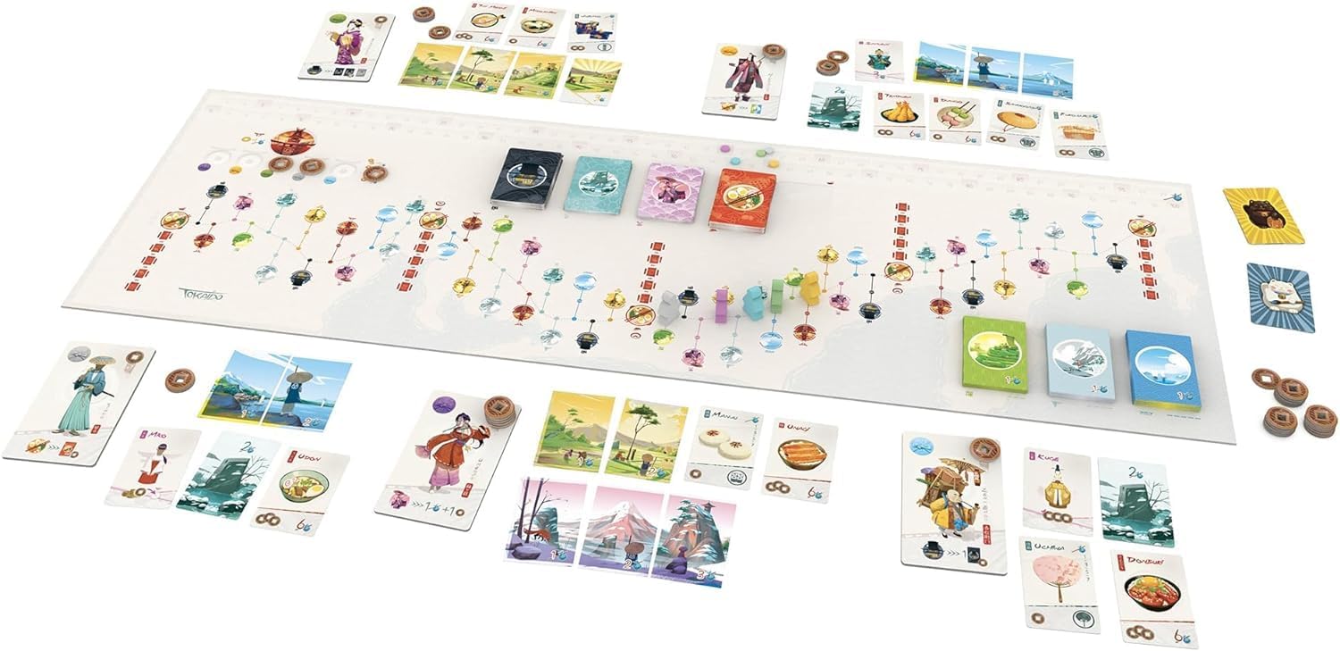 Setup of the Tokaido board game showing the main path, colorful cards with Japanese art, tokens, and pawns