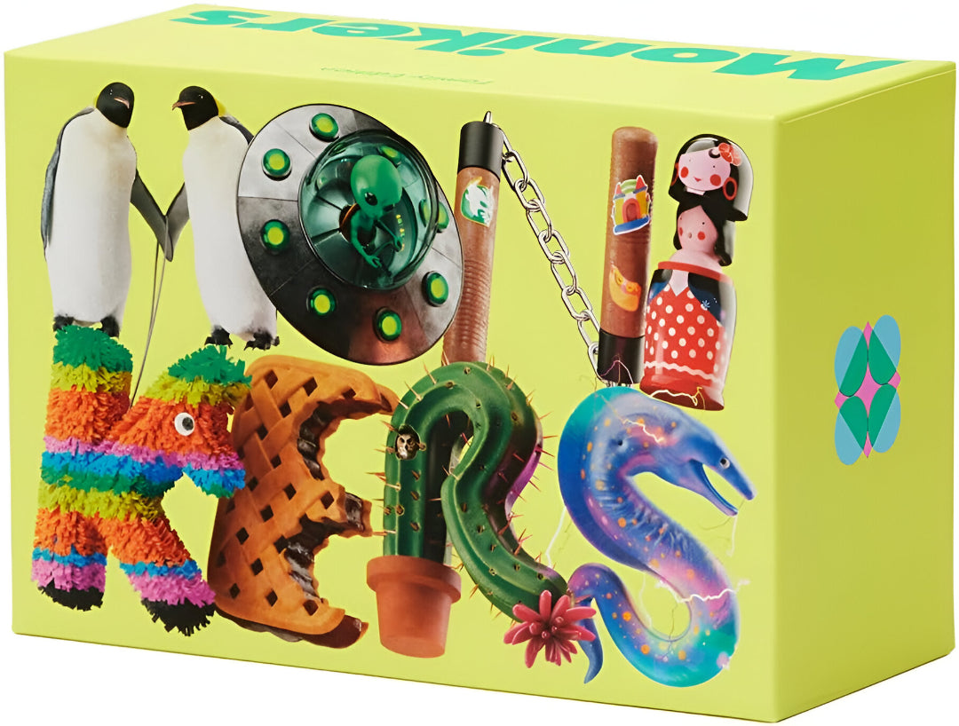 Monikers game box with a surreal collage of objects forming letters: penguins, UFO, cactus, and a colorful eel