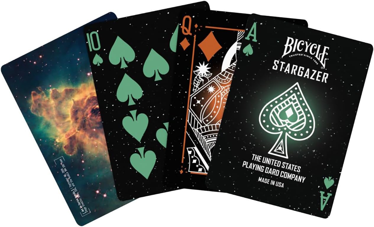 Fanned Bicycle Stargazer playing cards; black, starry background with green spades and nebula card back