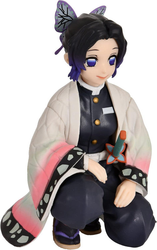 Demon Slayer Shinobu Kocho kneeling figurine with purple butterfly hairclips and teal and pink butterfly haori