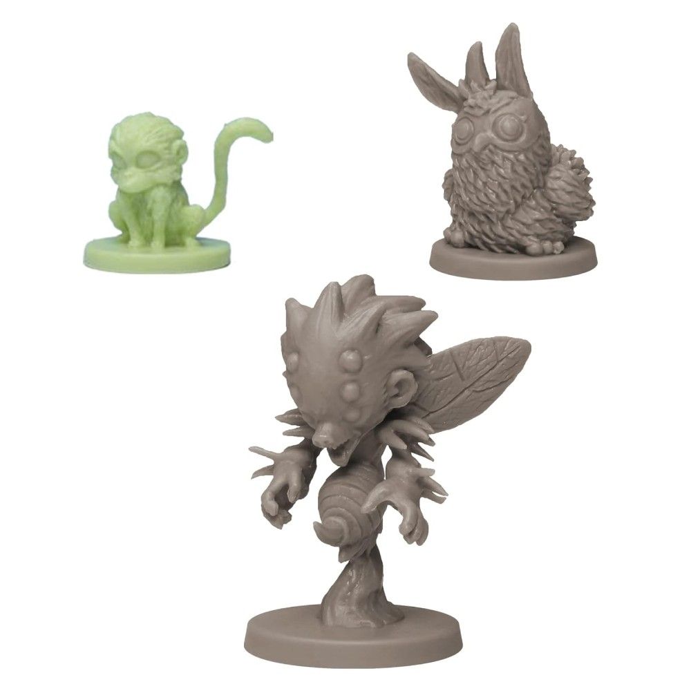 Three unpainted game miniatures: a green monkey, a grey furry owl-rabbit, and a grey winged insectoid monster lunging
