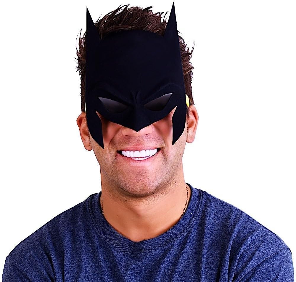 Batman mask with pointed ears covering a person's face and smiling mouth