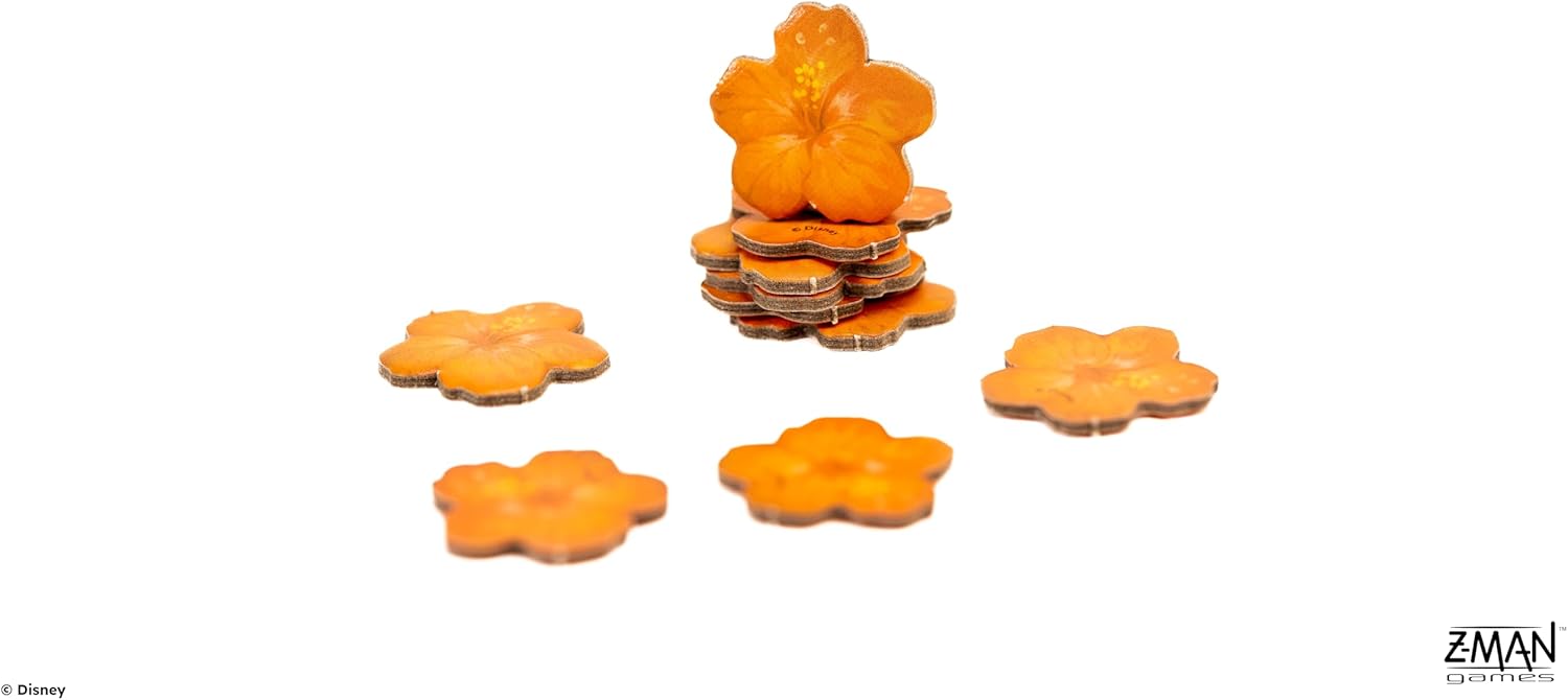 Orange hibiscus tokens stacked high, with several scattered on a white surface
