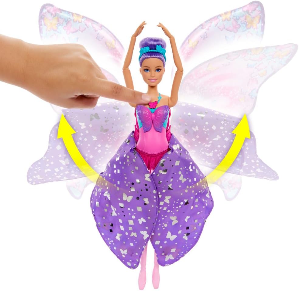 A hand presses a purple-haired Barbie doll's chest -  causing her glittery purple skirt-wings to spread open