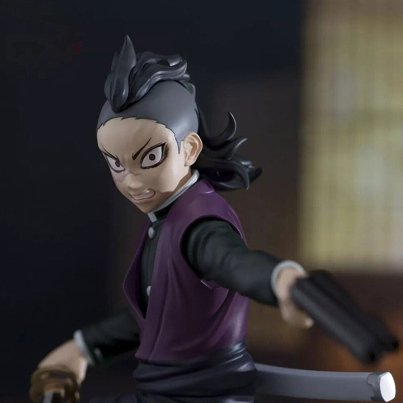 Anime figure of a Demon Slayer character in a black uniform and purple vest holding a sword and gun