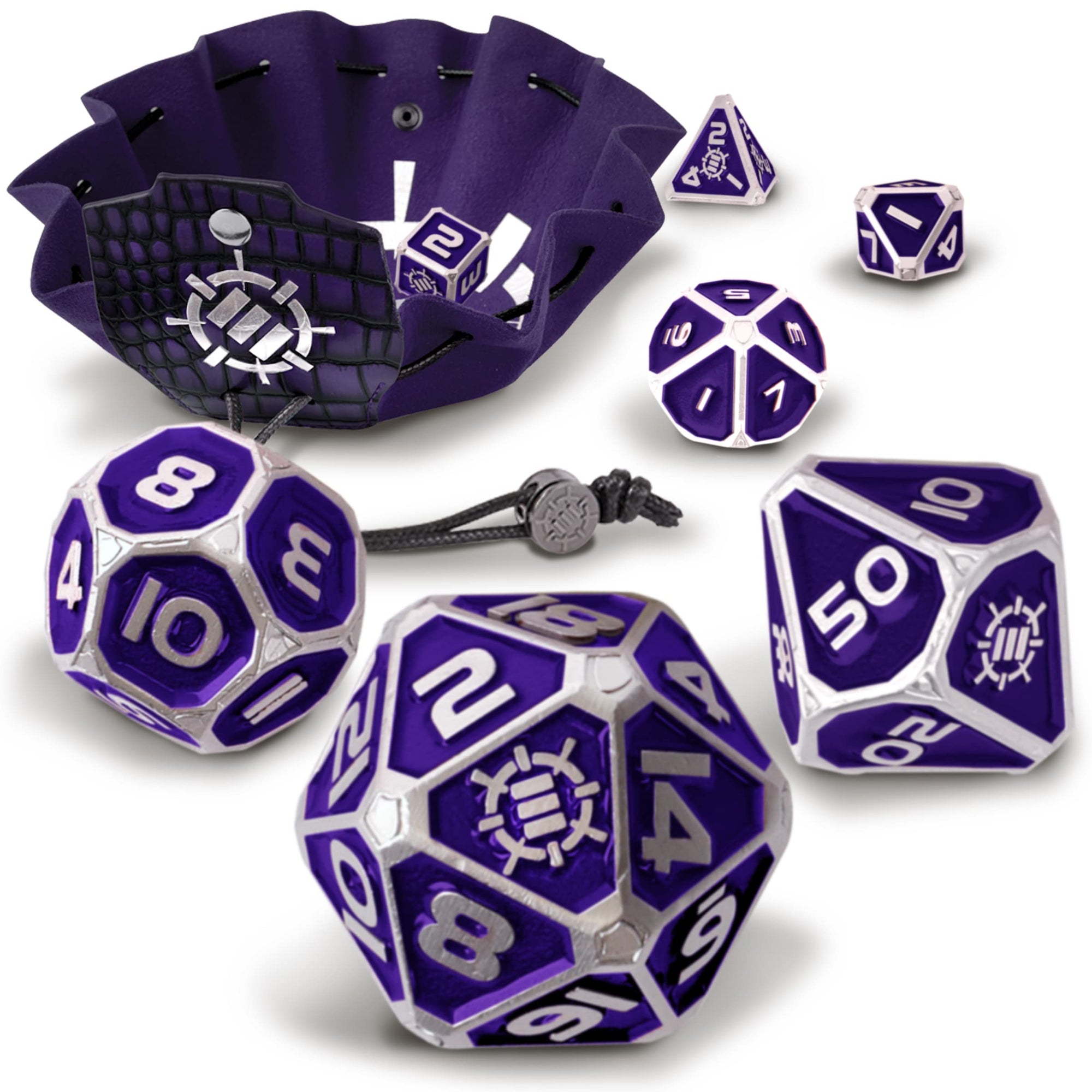 A purple and silver Enhance Tabletop Collector's Metal RPG Dice Set with a matching vegan leather bag and tray scattered on a white surface