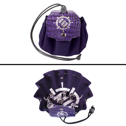 A purple vegan leather 2-in-1 bag and tray with a crocodile texture flap and silver symbol is shown closed and then open revealing metal RPG dice