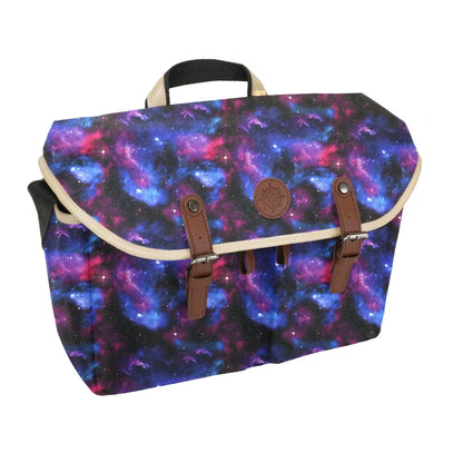 The Enhance Designer DnD bag features a vivid purple and blue galaxy nebula print on its flap, secured by twin brown faux leather buckle straps