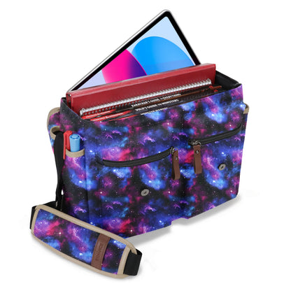 The Enhance Designer Edition D&D messenger bag featuring a striking cosmic galaxy pattern is packed with a tablet and multiple rulebooks for tabletop RPGs