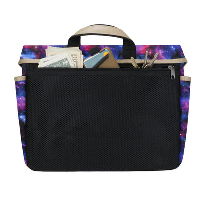 A rectangular galaxy-themed bag insert with beige trim and handle features a large black mesh pocket, showing keys and cash stored securely in the zippered top section