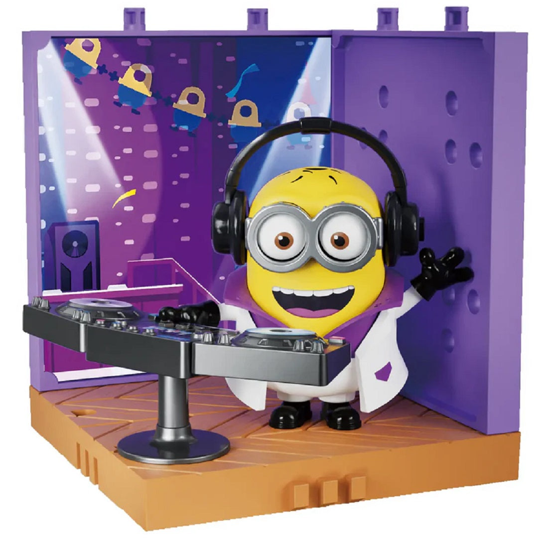 Minion toy figure dressed as a DJ, wearing headphones and standing behind a mixing console