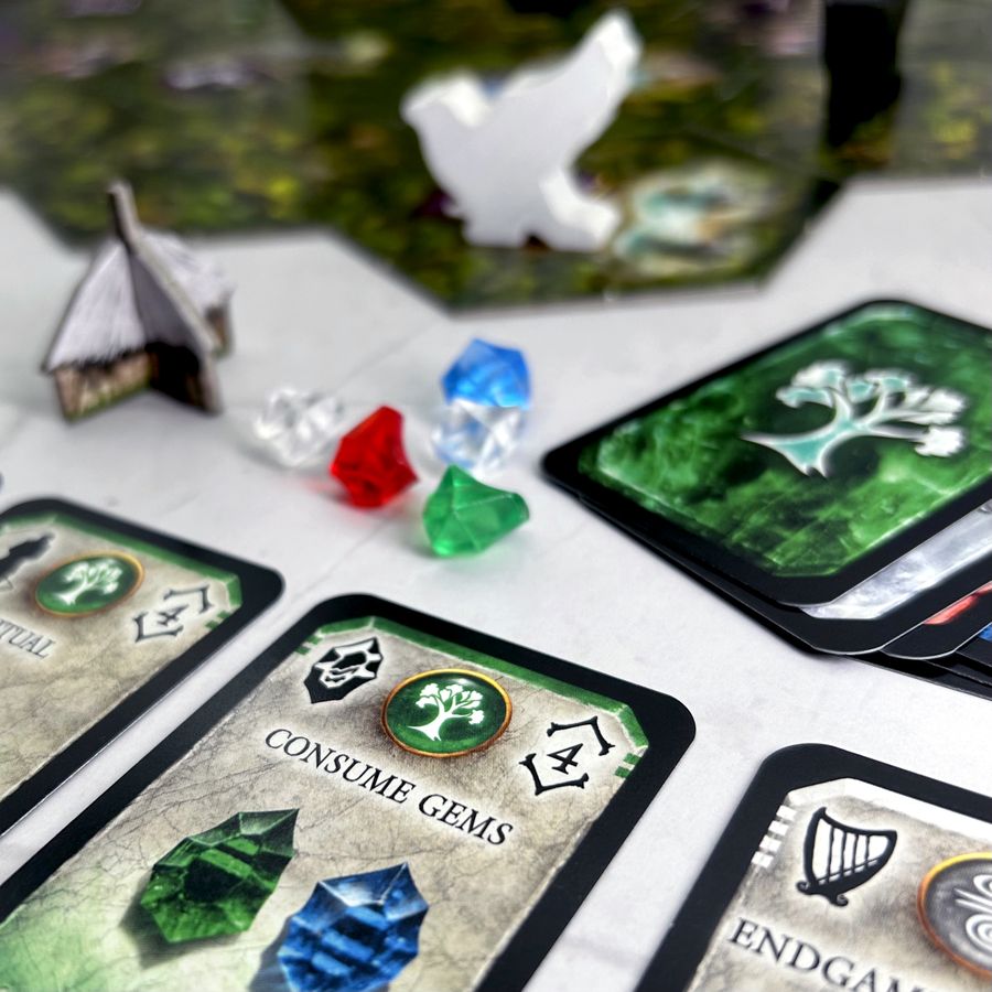 Elemental cards and round tiles displayed from the game