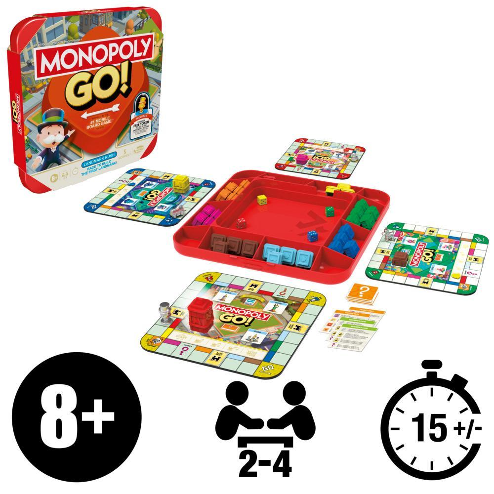 Monopoly GO! game set with its box, multiple small boards, a red tray full of game pieces, dice, and cards