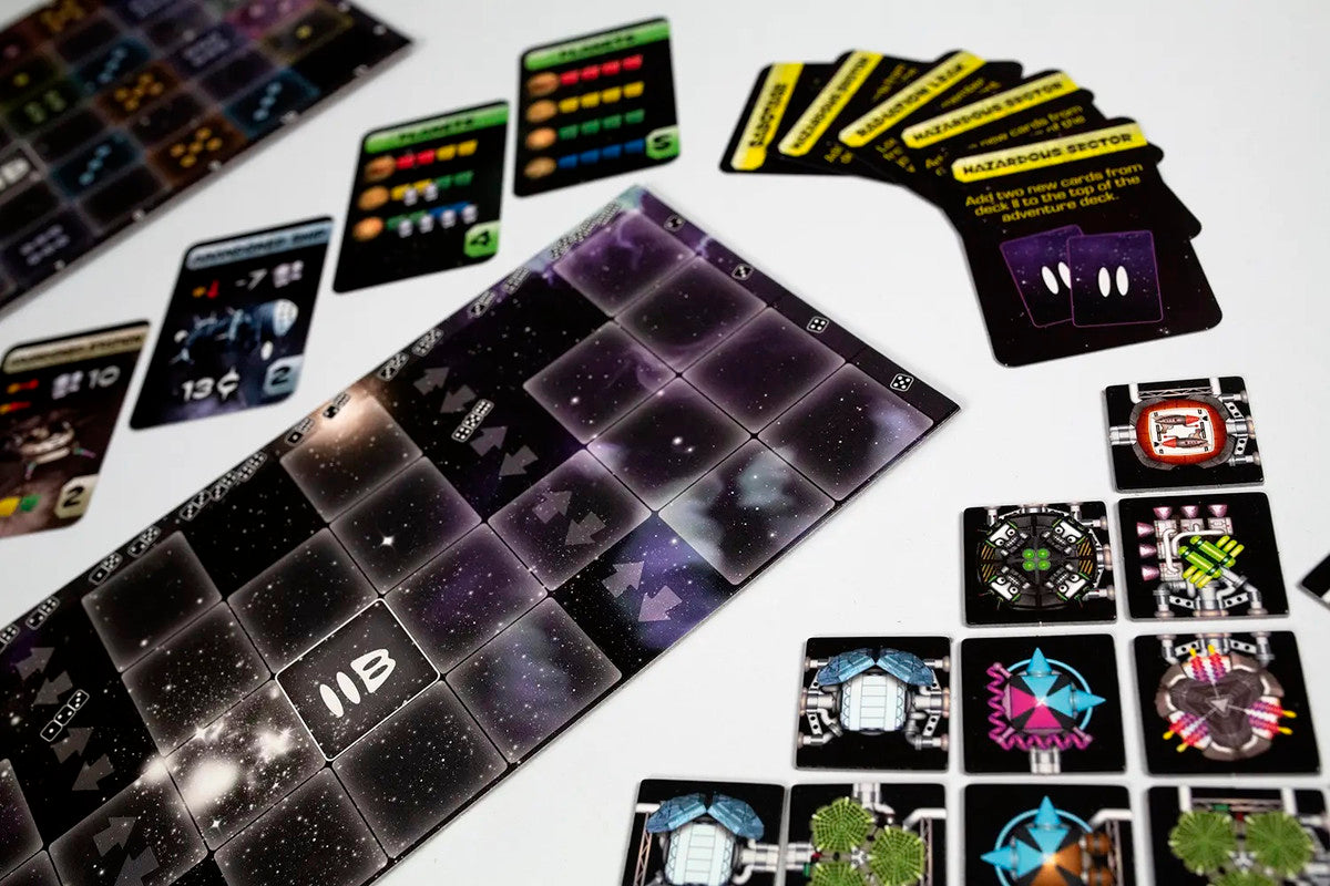 Overhead shot of a space-themed board game, showing a galaxy grid board, various cards, and tech tiles on white