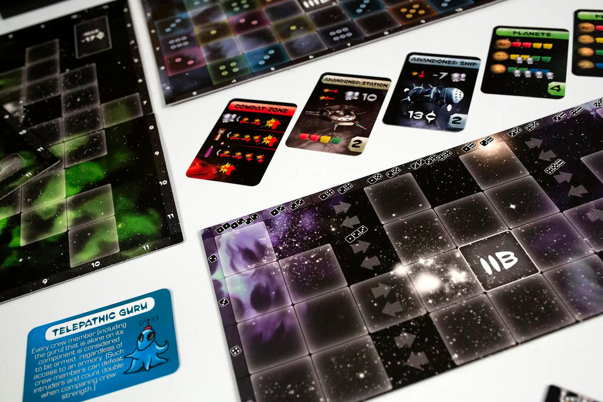 Close-up of sci-fi board game components: space-themed boards, and cards like 'Combat Zone' and 'Telepathic Guru'