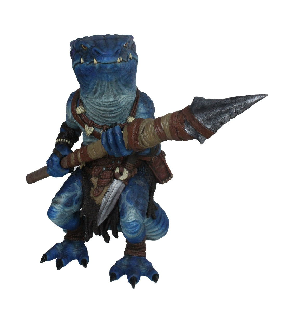 A blue reptilian kobold figure in tribal gear with sharp teeth, holding a large spear across its body