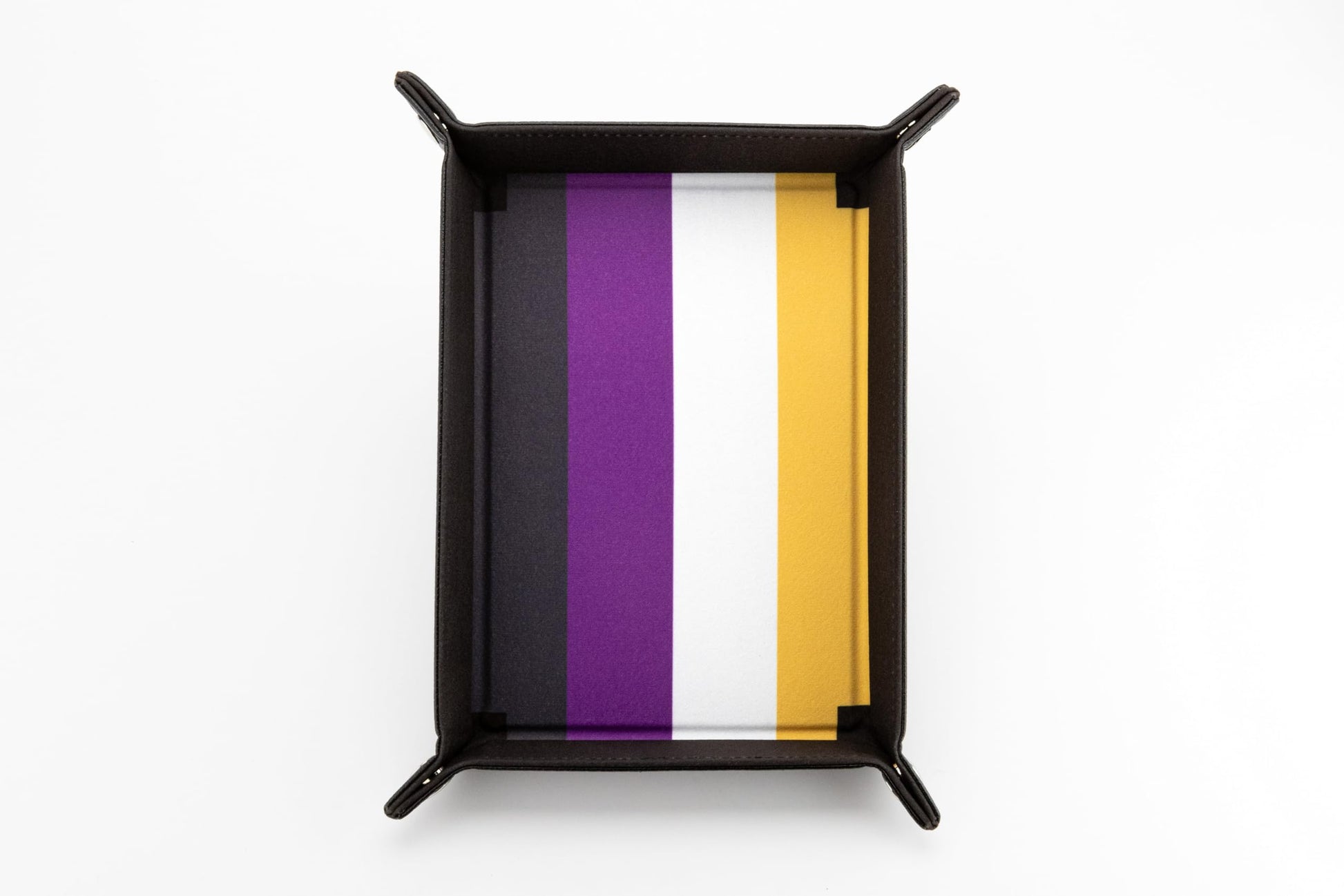 Nonbinary velvet dice tray featuring black, purple, white, and yellow stripes contained within dark brown folded edges