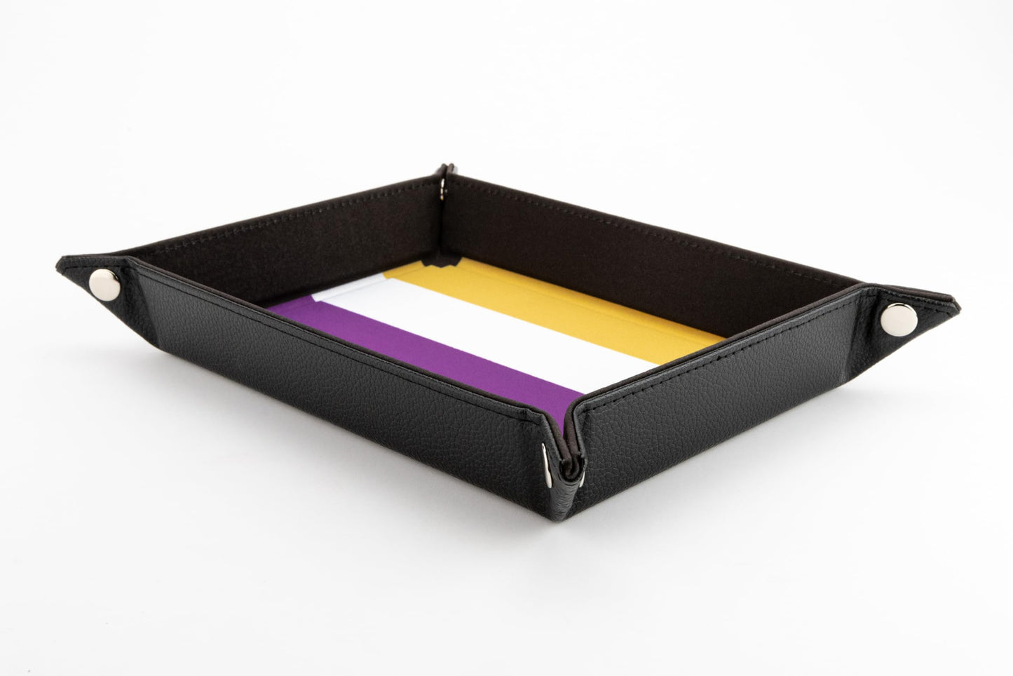A rectangular black velvet dice tray featuring the yellow, white, and purple Nonbinary flag pattern on the interior base and silver corner snaps