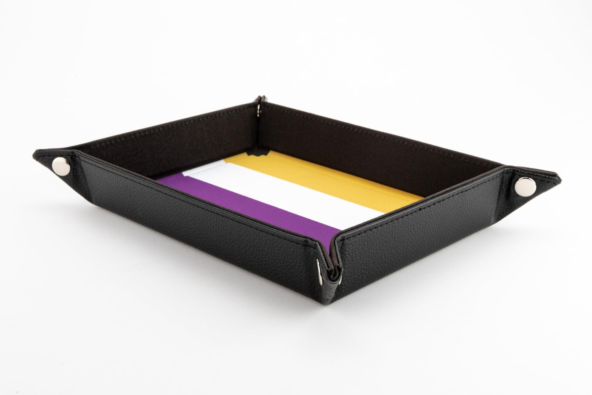 A rectangular black velvet dice tray featuring the yellow, white, and purple Nonbinary flag pattern on the interior base and silver corner snaps