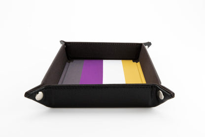 Nonbinary velvet dice tray snapped into shape, featuring the flag colors dark gray purple white and yellow inside a black textured exterior