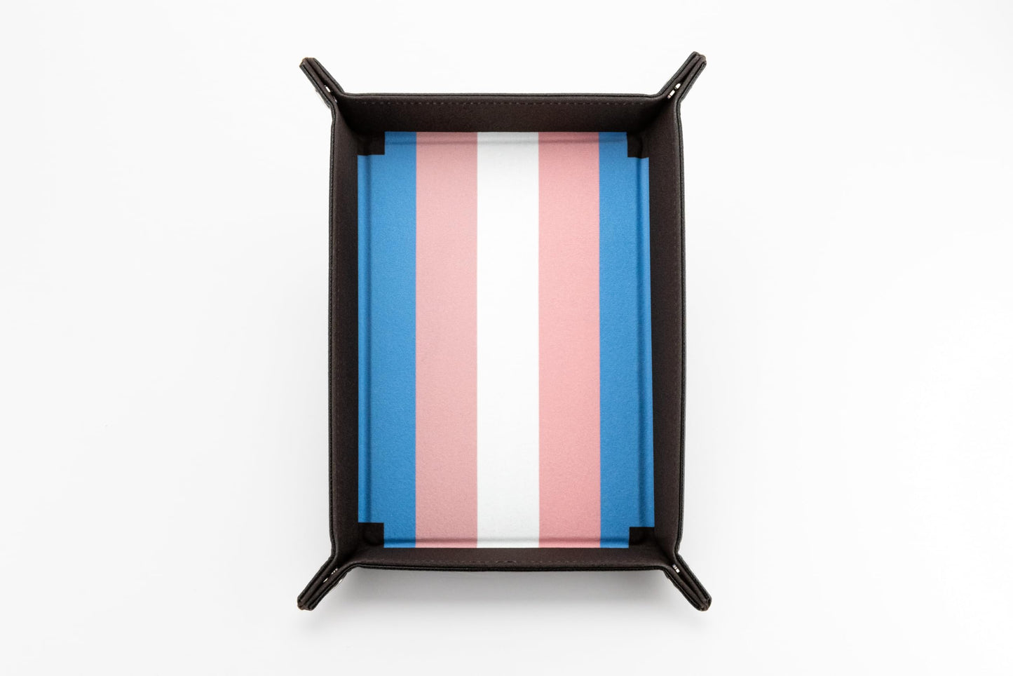 The Fanroll foldable dice tray featuring a dark brown exterior and a plush blue, pink, and white striped interior representing the Transgender Pride Flag