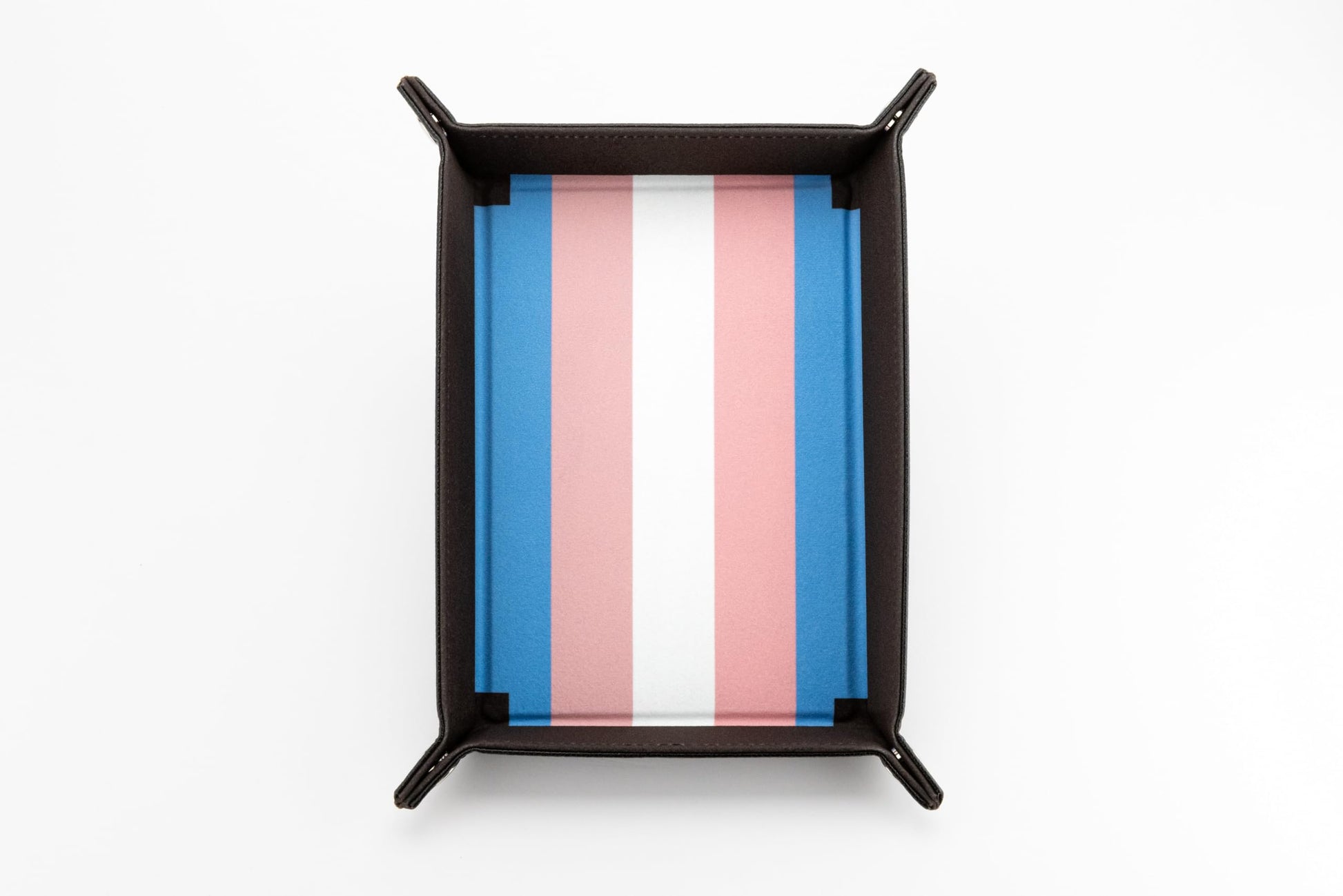 The Fanroll foldable dice tray featuring a dark brown exterior and a plush blue, pink, and white striped interior representing the Transgender Pride Flag