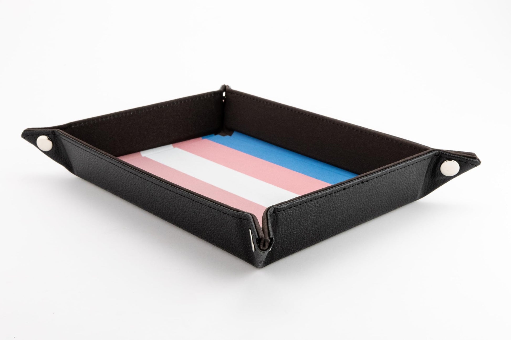 A folded dice tray with black exterior walls and an interior playing surface patterned in the pink white and blue stripes of the Transgender Pride flag