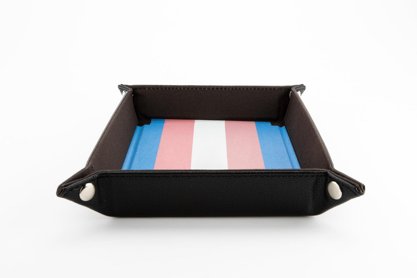 Foldable black dice tray with silver corner snaps and an interior surface printed with the distinctive blue pink and white Transgender Pride flag