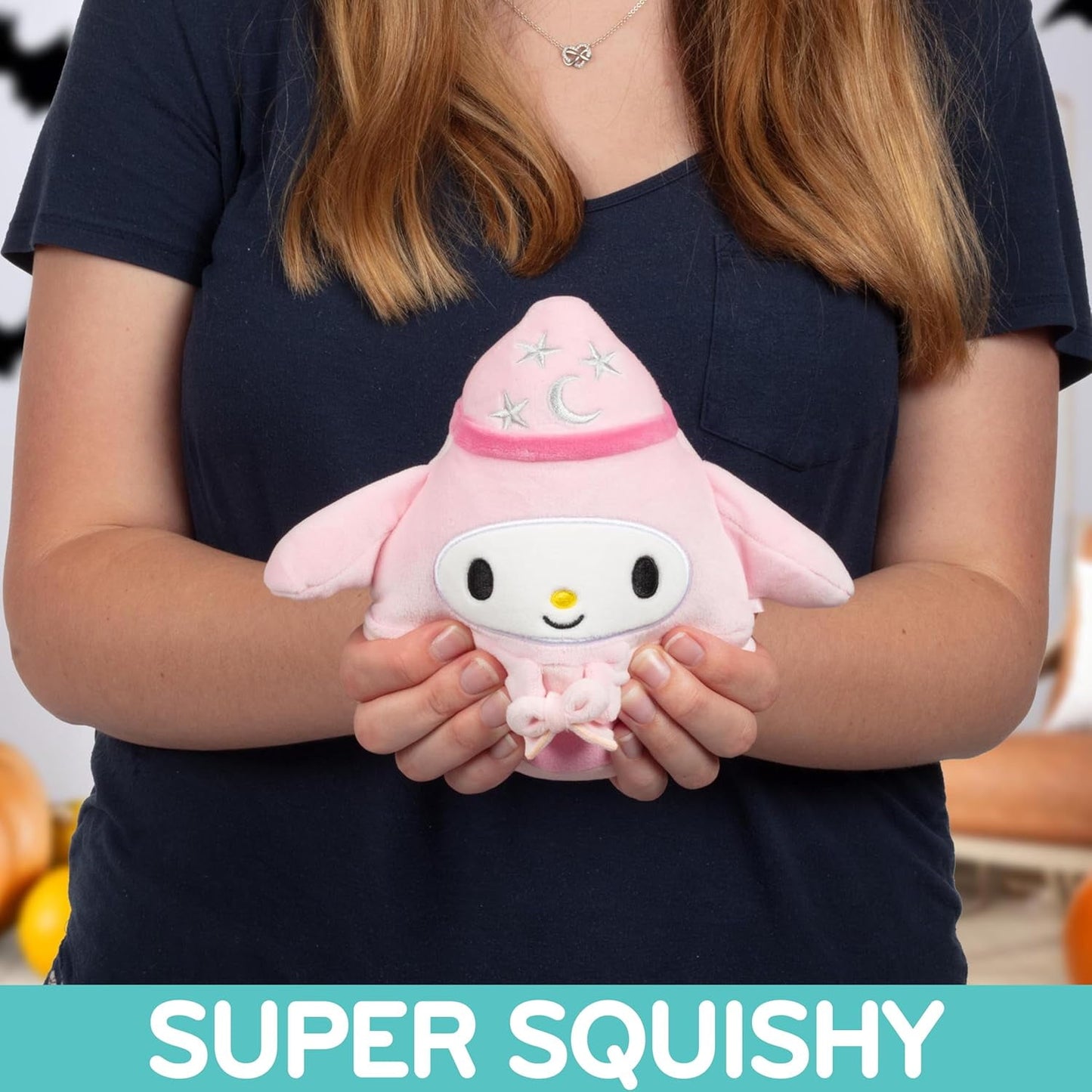 Person holding a pink My Melody plush in a wizard costume