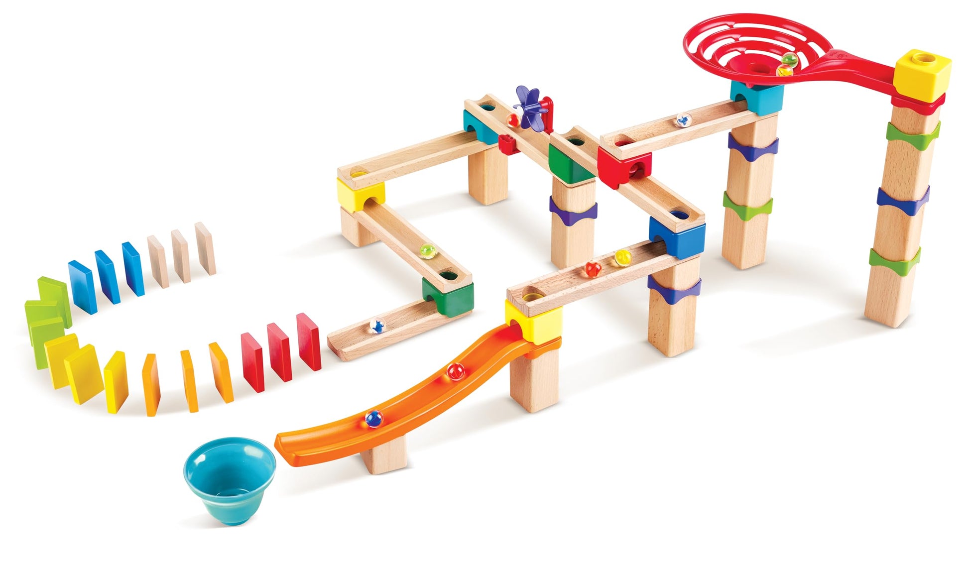 Modular wooden marble run kit showcasing elevated tracks, several moving marbles, a large red spiral funnel, and a rainbow sequence of standing dominoes