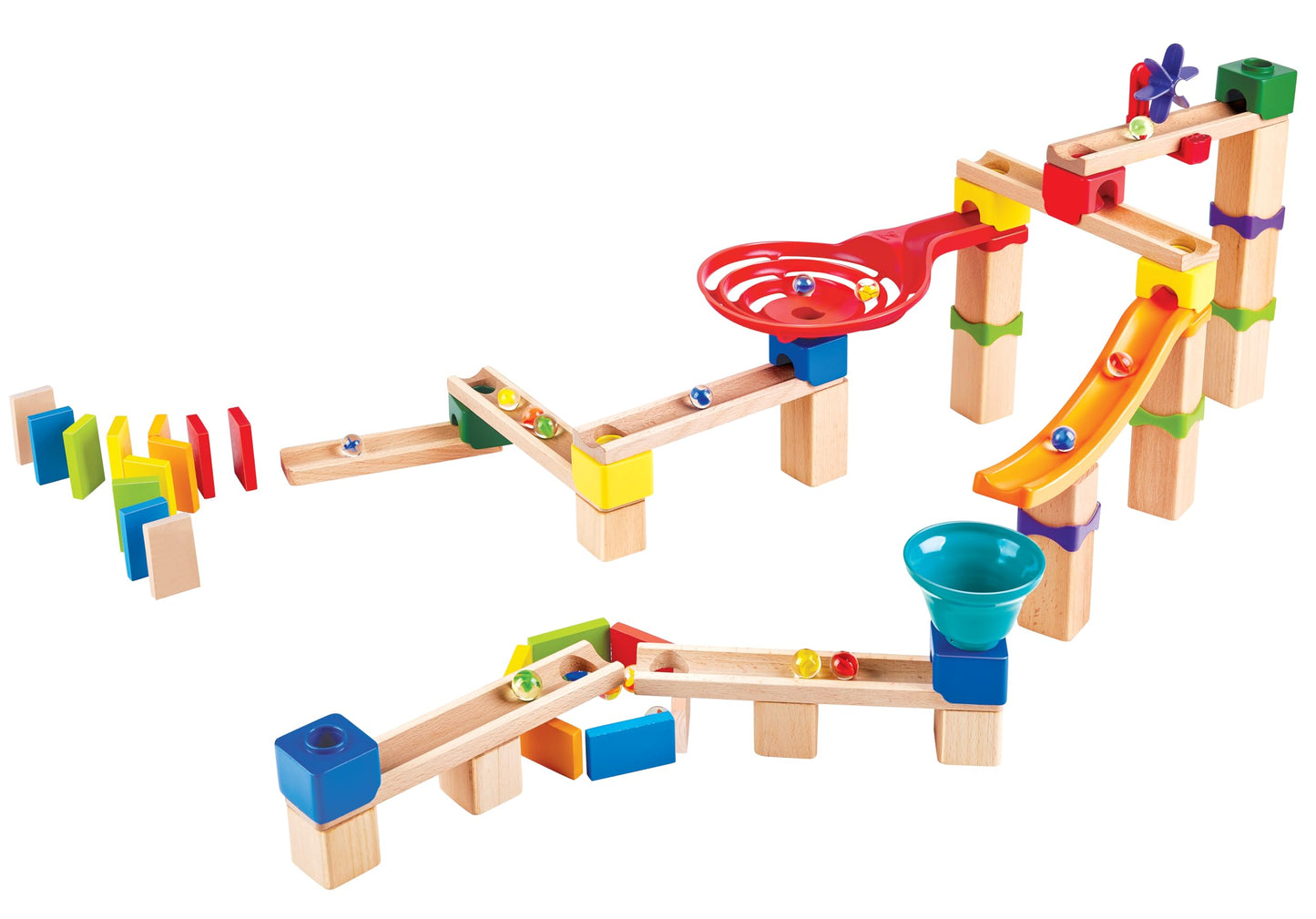 Complex wooden marble run assembled with colorful plastic pieces, showing marbles rolling past a red spiral funnel, orange slide, and standing dominoes
