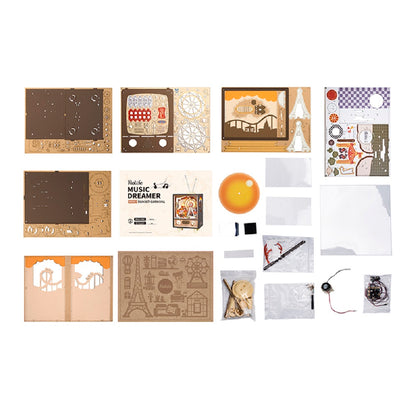 Layout of the Music Box Sunset Carnival kit with laser-cut wood parts for the vintage television frame and internal Ferris wheel, plus a speaker and various electrical components