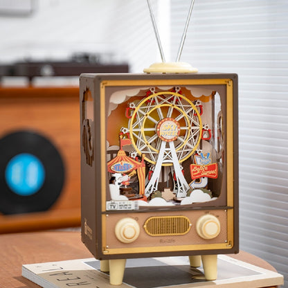 Brown miniature music box designed as a retro TV with antennae, showcasing a 3D paper craft scene of a carnival featuring the large Sky Wheel