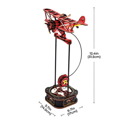 The completed red Rokr Gravity Swing Sky Captain biplane wooden model stands 124 inches tall above its map-detailed mechanical base