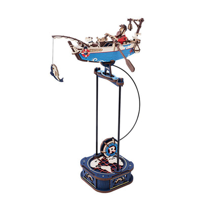 The assembled Rokr Gravity Swing Ocean Fisher wooden puzzle model features a blue boat with a fisherman and a caught fish balanced on a kinetic base
