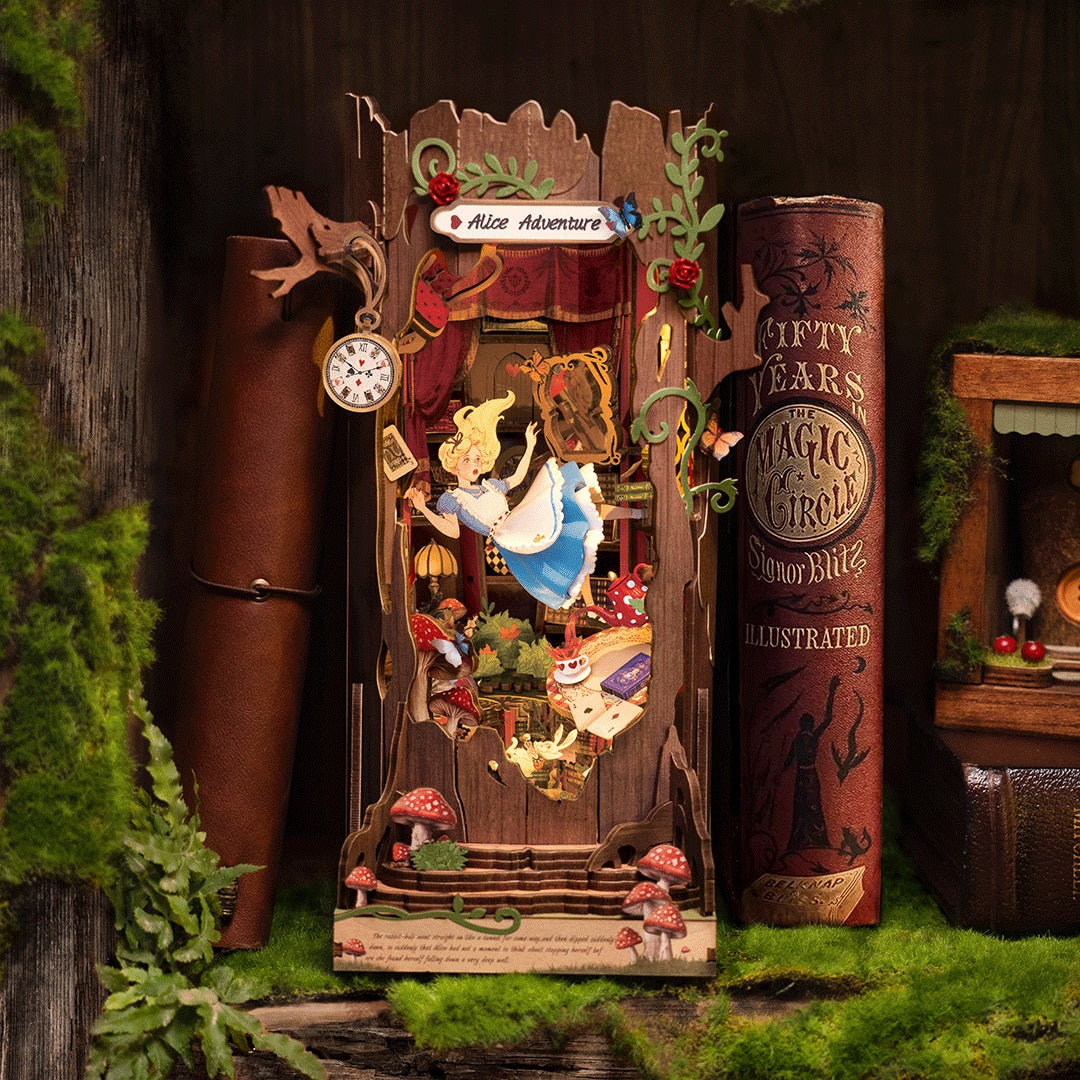 3D wooden book nook diorama depicting Alice falling down the rabbit hole, surrounded by books and moss