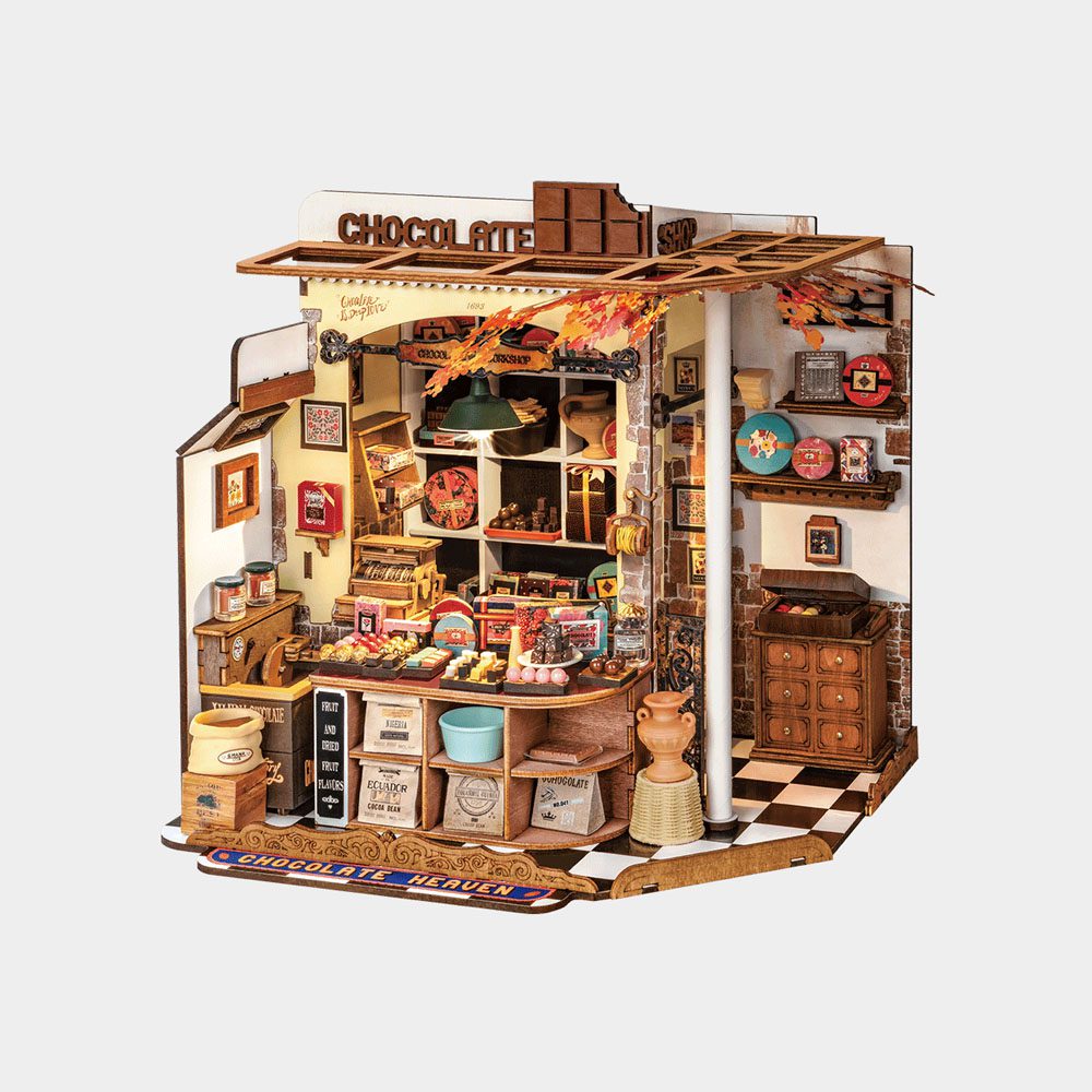 The intricate Diy Mini House Herys Chocolate kit shows a vintage shop interior filled with miniature sweets, cocoa bags, and detailed furniture