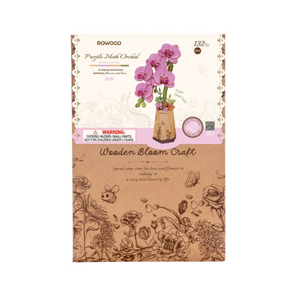 Detailed packaging for the Rowood Purple Moth Orchid wooden craft kit shows the 132-piece purple flower assembly and is labeled for ages fourteen and up