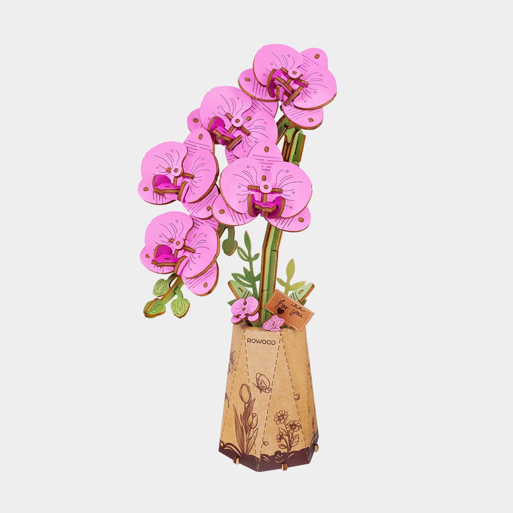 The assembled Wood Bloom Purple Moth Orchid 3D puzzle shows pink flowers in a decorative brown pot, complete with a small wooden "For you" sign