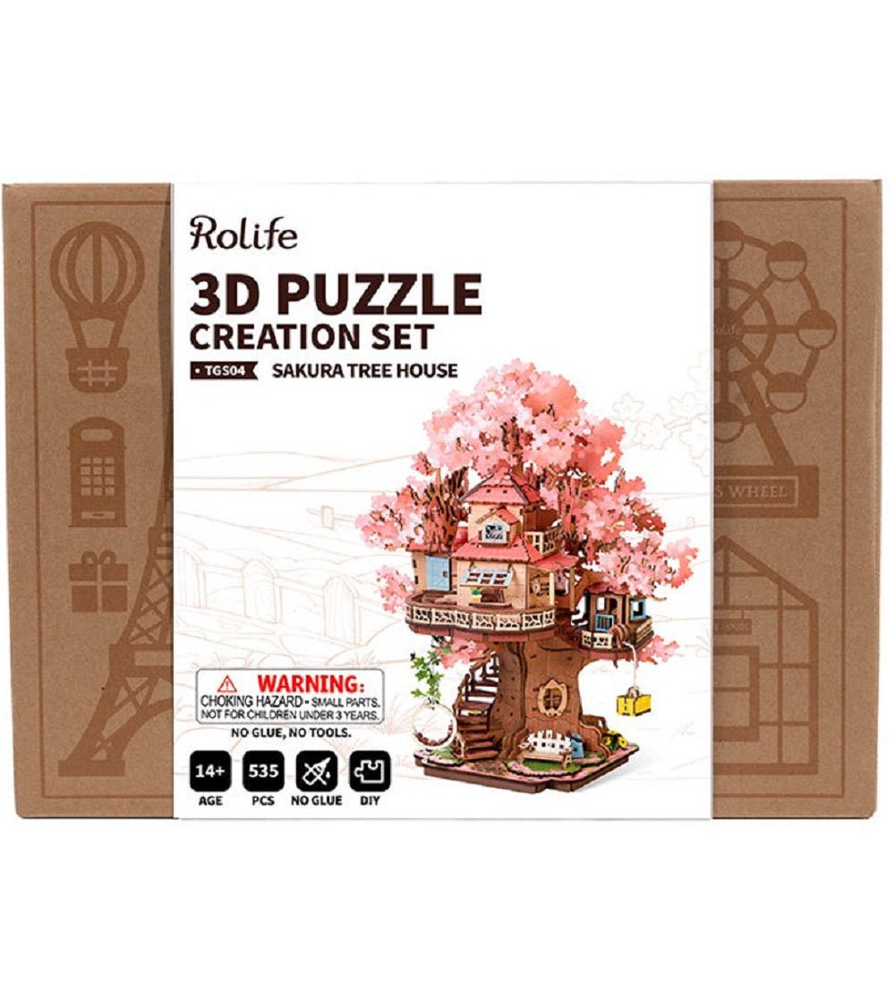 Rolife 3D Puzzle Creation Set box displays the 535-piece Sakura Tree House model featuring pink blossoms and requiring no glue or tools