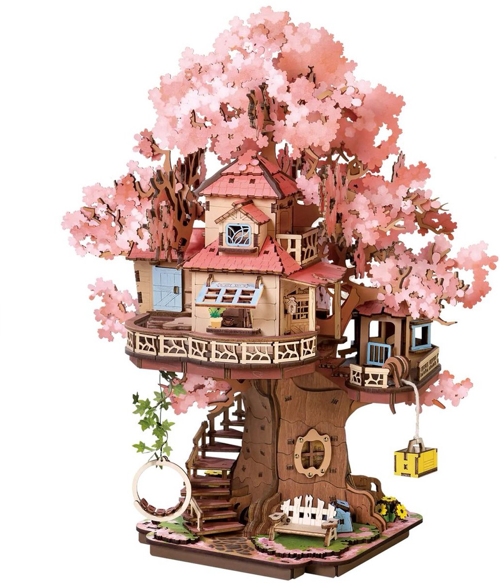 This wooden DIY miniature Sakura tree house features pink cherry blossoms, a detailed main cabin, a wrap-around balcony, stairs, and a small ground-level garden setting