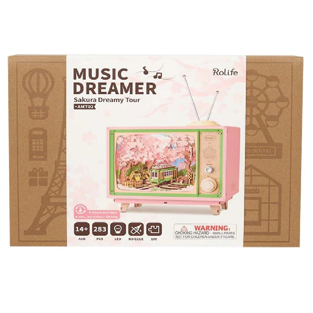 The Rolife Music Dreamer Sakura Dreamy Tour DIY kit packaging features a pink retro TV music box with a miniature cherry blossom and green trolley scene