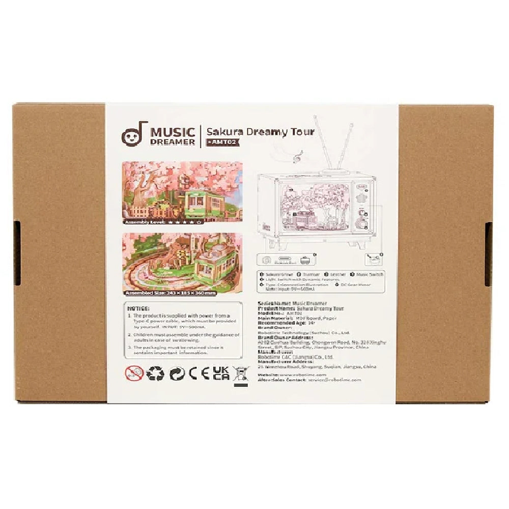 Back view of the Sakura Dreamy Tour music box packaging showing the miniature TV scene with a streetcar, listing the assembled size as 243 x 185 x 360 mm and key features