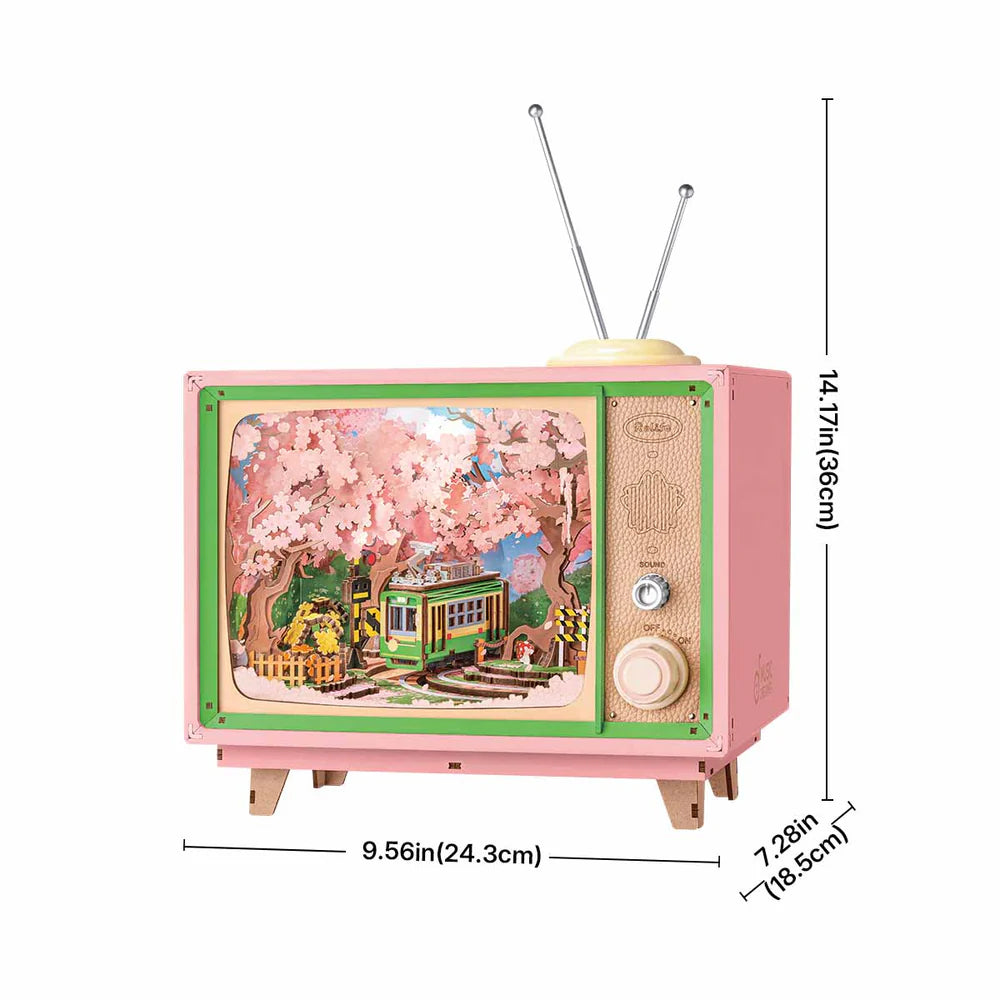 This pink retro TV-style music box featuring a cherry blossom trolley scene is dimensioned as 956in wide 1417in high and 728in deep