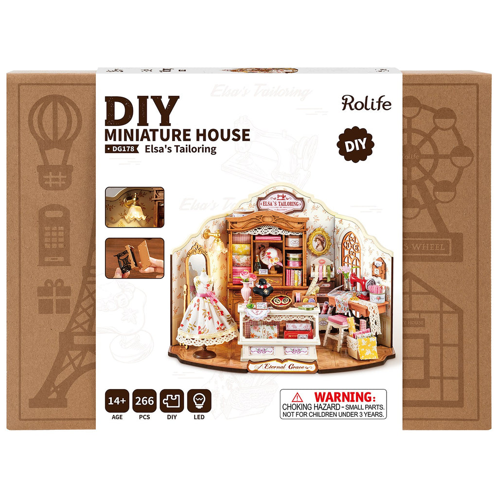 Packaging for the DG178 Elsa's Tailoring DIY Miniature House showing the fully assembled 266-piece LED-lit dollhouse boutique storefront kit box design