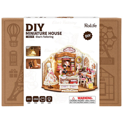 Packaging for the DG178 Elsa's Tailoring DIY Miniature House showing the fully assembled 266-piece LED-lit dollhouse boutique storefront kit box design